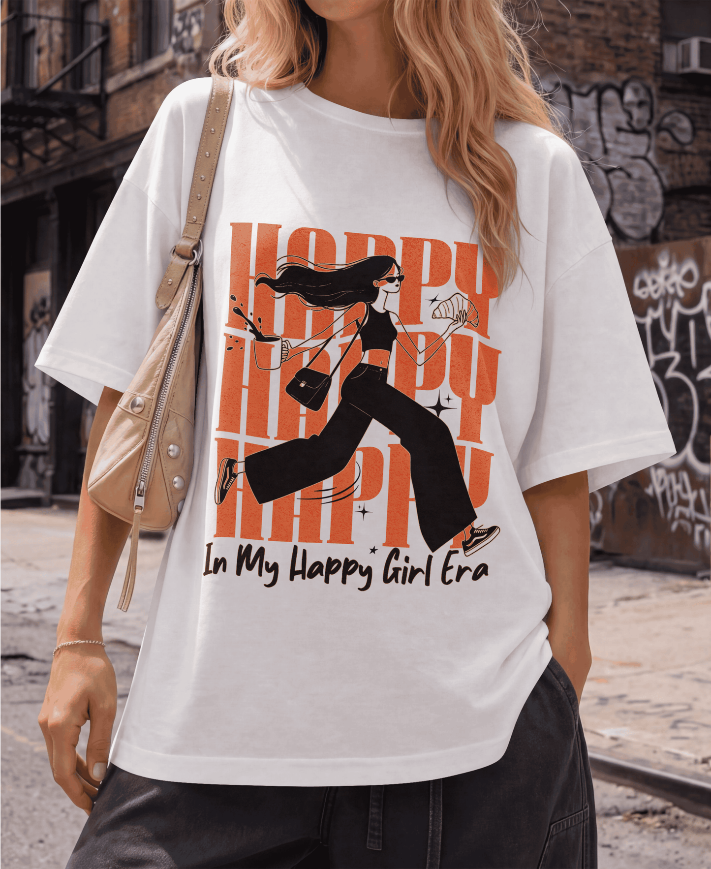 Person wearing a white t-shirt with a graphic design and text in an urban setting.